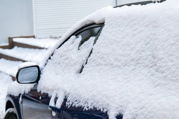 istock The car, covered with thick layer of snow. Negative consequence of heavy snowfalls. Side hundred cars with different patterns. 1352240634