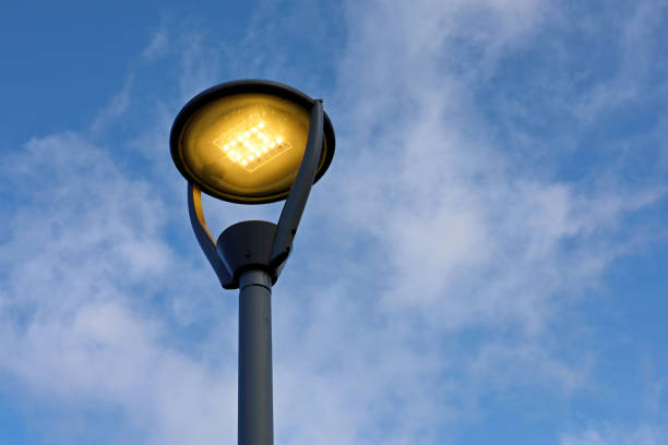 istock Glowing led lamp on background of blue sky with white clouds 1352241295
