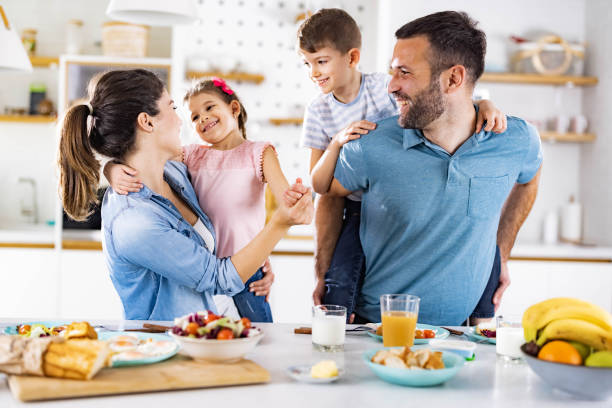 istock Happy family having fun during breakfast in dining room. 1352243532