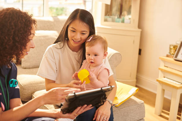 istock health visitor explaining to mother 1352244470