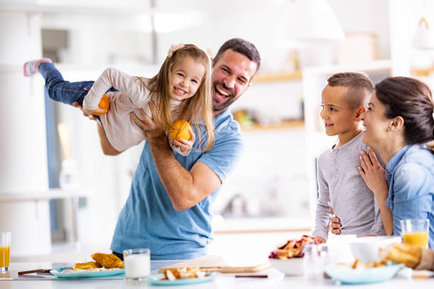 istock Cheerful family having fun in dining room. 1352244826