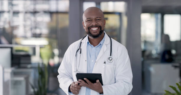 istock Shot of a mature male doctor using a digital tablet at work 1352245245