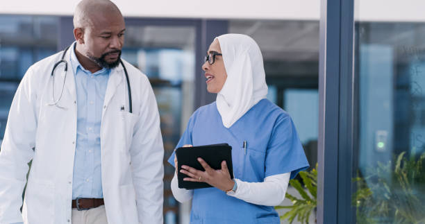 istock Shot of two medical professionals using a digital tablet in an office at work 1352245250