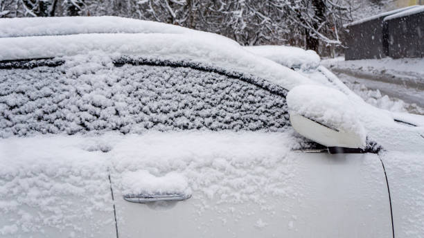 istock The car, covered with thick layer of snow. Negative consequence of heavy snowfalls. Side hundred cars with different patterns. 1352245948