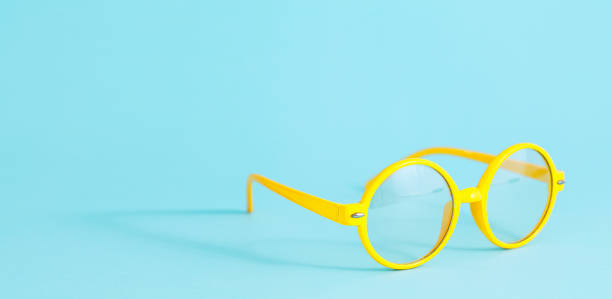istock Yellow round glasses on light blue background with copy space 1352247393