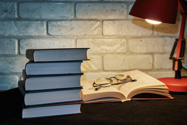 istock Books, glasses and a table lamp 1352247548
