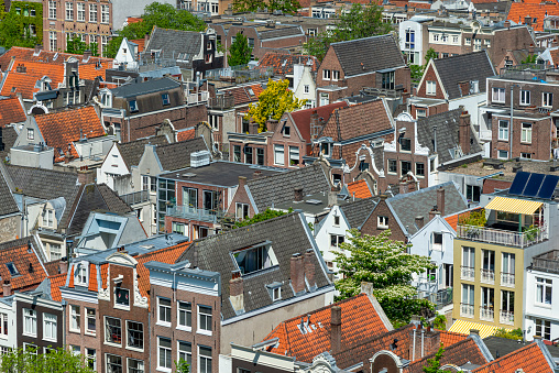 Roofs and facades of Amsterdam. City view to the south from the bell tower of the church Westerkerk, Holland, Netherlands.