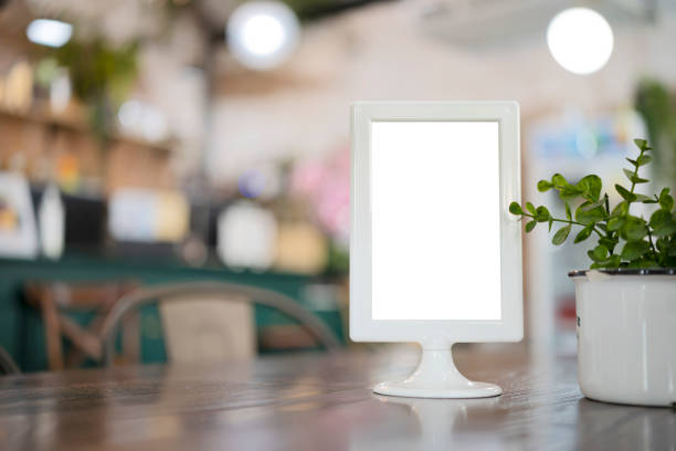 istock Mock up menu frame on table with restaurant cafe shop 1352249305