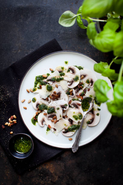 istock Mushroom carpaccio with basil pesto and parmesan and pine nuts 1352250639