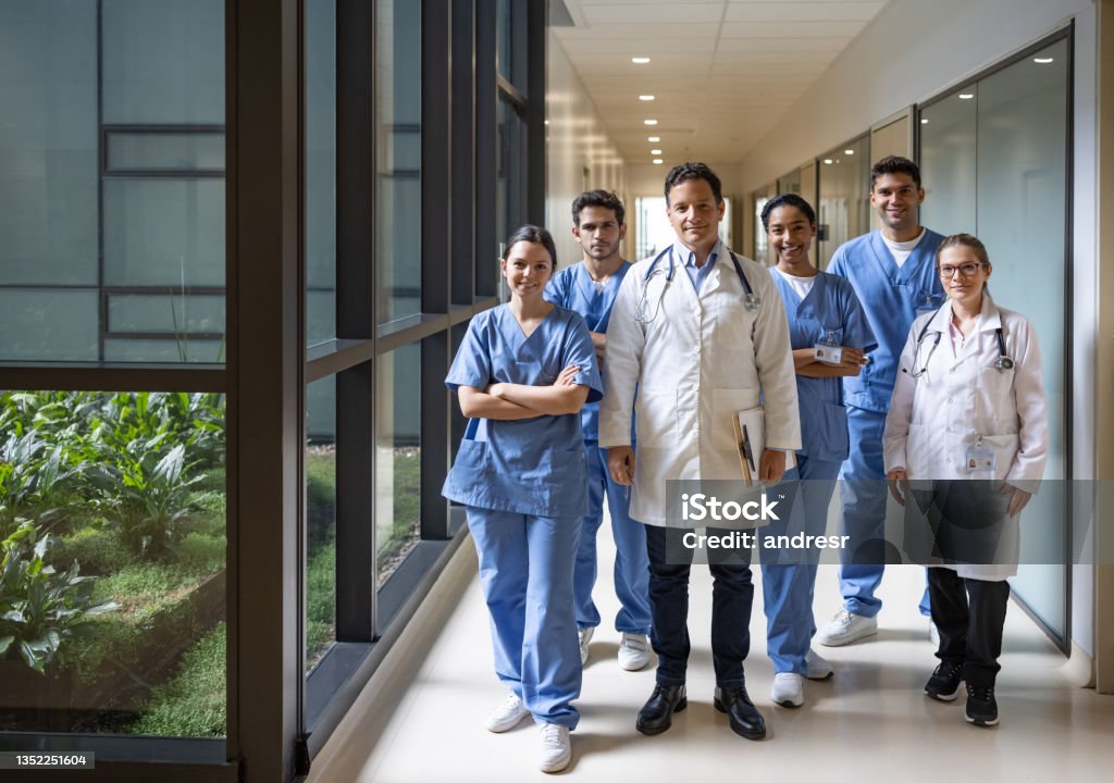 Team of doctors and nurses working at the hospital Happy Latin American team of doctors and nurses working at the hospital and looking at the camera smiling - healthcare and medicine concepts Doctor Stock Photo