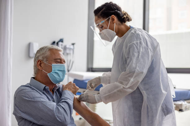 Adult man getting the COVID-19 vaccine at the hospital stock photo