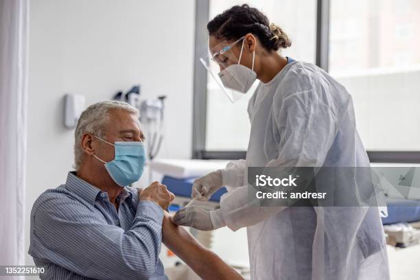 Adult Man Getting The Covid19 Vaccine At The Hospital Stock Photo - Download Image Now