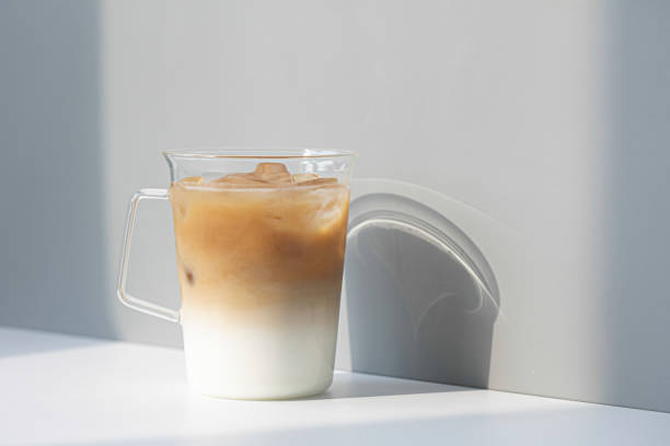 istock caffe latte in glass on white table. 1352254150