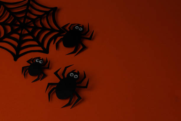 istock Halloween holiday. Composition with different halloween paper figures. view from above. on orange background 1352254165