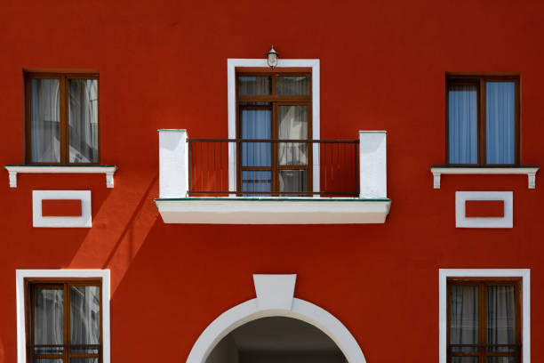 istock fragment of the facade of a red building with windows, balcony and decorative elements 1352254514