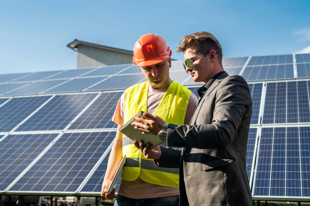 istock foreman and engineer  work during checking and repairing solar photovoltaic panel 1352255589