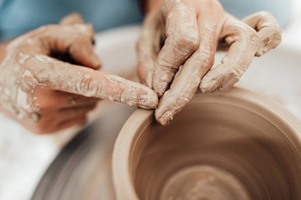 istock Female potter hands close up 1352255633