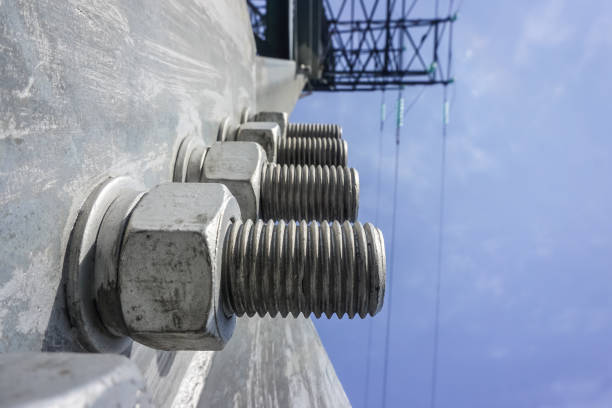 Several steel bolts and nuts on an electric tower
