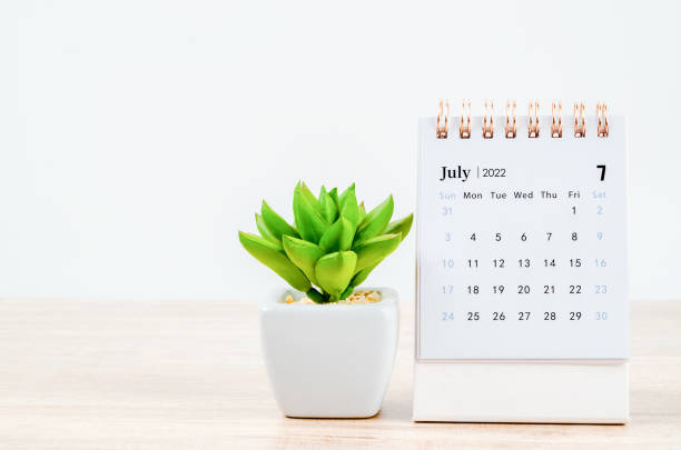 istock July 2022 desk calendar on wooden table. 1352256374