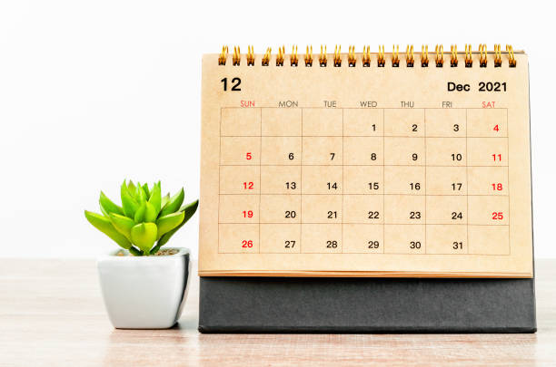 istock December 2021 desk calendar on wooden table. 1352256383