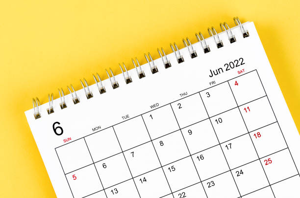 istock June 2022 desk calendar on yellow background. 1352256414