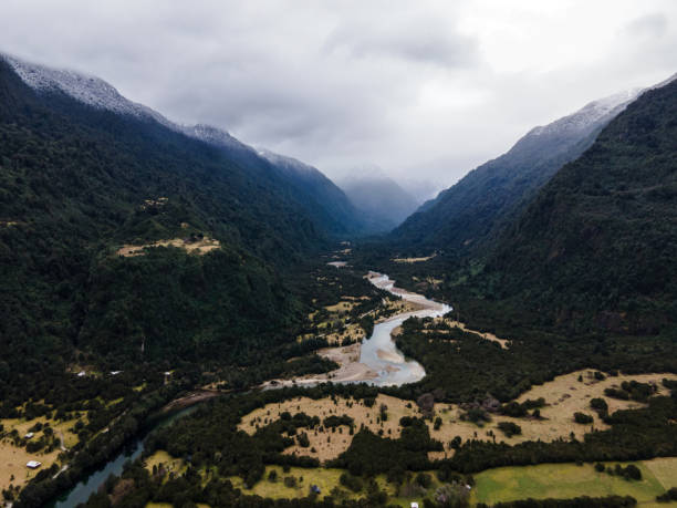 istock Aerial view of the Cochamo valley with its snow-capped mountains and its characteristic river. 1352257144