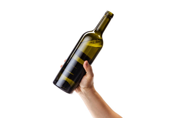 istock Cropped image of male hand holding bottle of white wine isolated over white background 1352257284