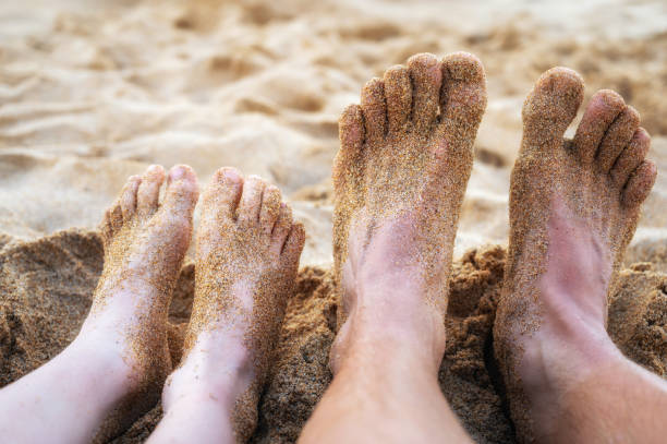 istock Feet of father and son on a beach on summer vacation 1352257348