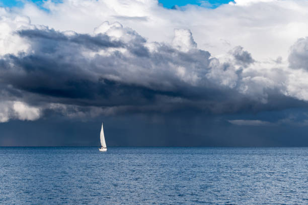 istock Panoramic view of a sailboat with a background full of storm clouds on lake llanquihue in frutillar, Chile. 1352257403