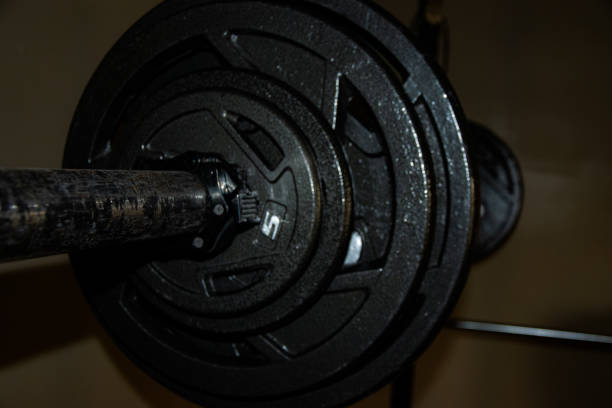 istock Weight bar and weights on rack 1352257509