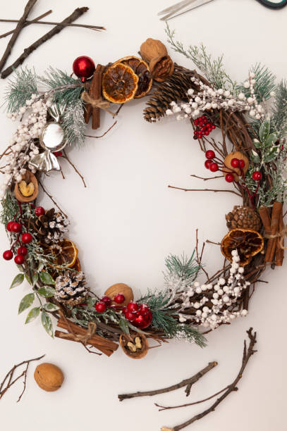 istock Making a Christmas and New Year's wreath DIY on a white background. Holiday decorations. Top view, DIY concept, copy space 1352257993
