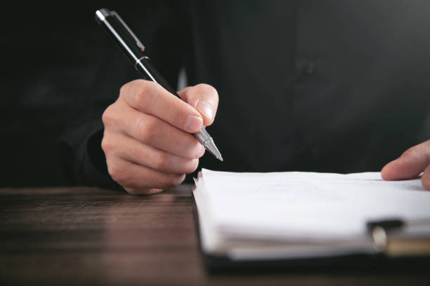 istock Male Judge signing in document. Justice and Law concept 1352258002