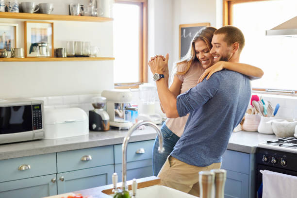 istock Loving couple dancing together in kitchen at home 1352259108