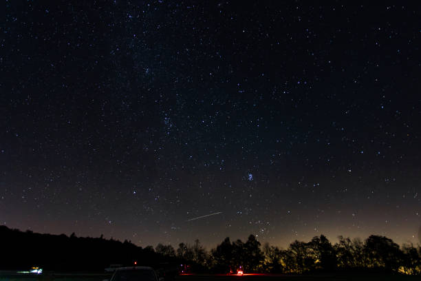 istock people watching the stary night sky in the mountains 1352259315