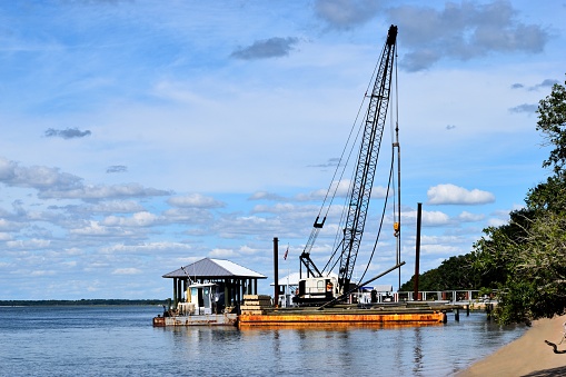 Construction barge building a private dock on the river at St. Augustine, Florida.