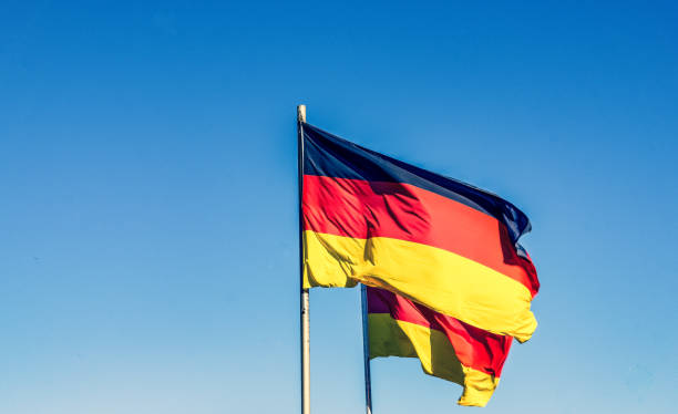 istock Two German national flags in the wind. 1352259382