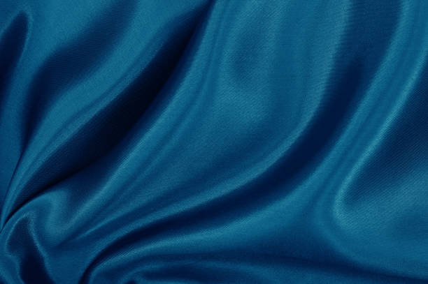 istock Dark blue fabric cloth texture for background and design art work, beautiful crumpled pattern of silk or linen. 1352260415