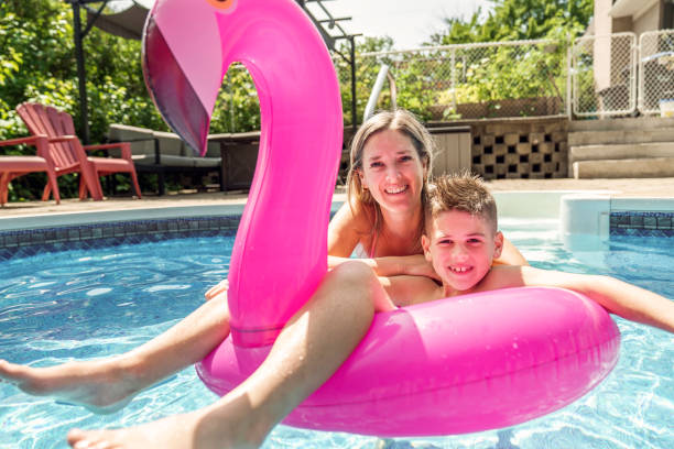 istock mother and son having fun in swimming pool 1352261039