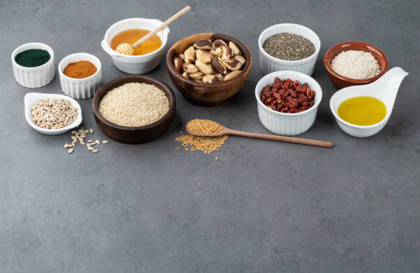 istock Assorted superfoods in spoons over stone background with copy space. Chia, quinoa, oat, linseed, honey, spirulina and others 1352261068
