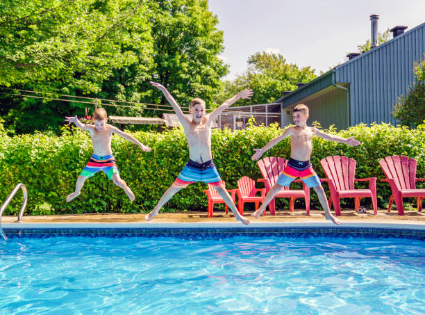 istock Childrens playing in pool on summer time jumping 1352261148