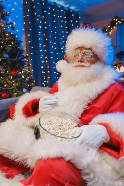 istock Indignant Santa Claus is watching TV, probably he saw something unexpected there 1352261797