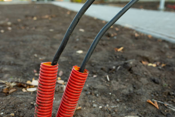 Large red plastic corrugated pipes with wires for connecting lighting on construction site Large red plastic corrugated pipes with wires for connecting lighting on the construction site pvc conduit stock pictures, royalty-free photos & images