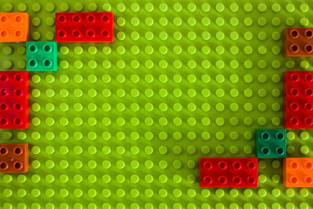 istock Colorful plastic building blocks on a green matwith empty copyspace 1352263282