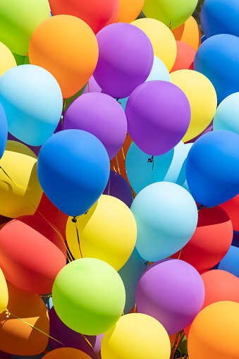 Many colorful balloons decorated wall as background.