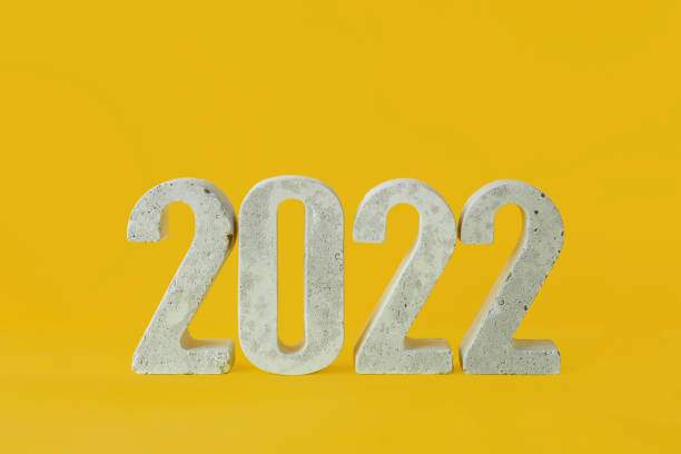 istock concrete numbers 2022 on a yellow background. 1352264951