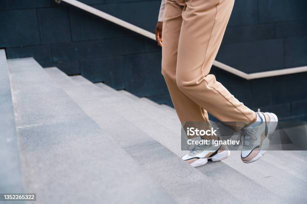 A Female Legs Ascending The Stairs Stock Photo - Download Image Now - Sports Shoe, Women, Staircase