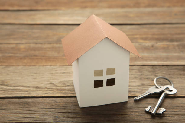 istock Paper house and key on grey background with copy space. 1352267915