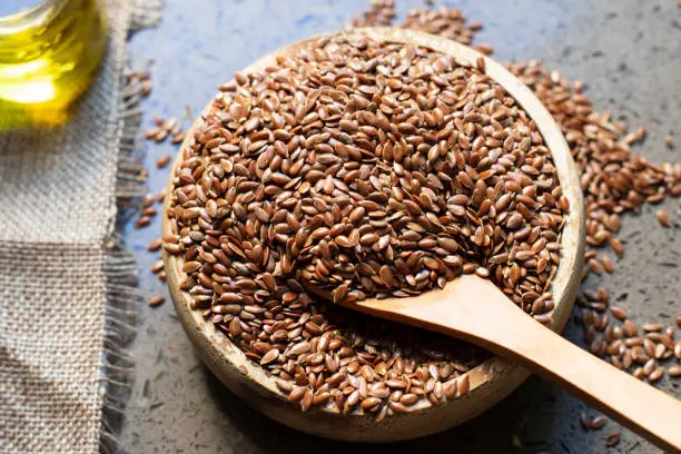 Flax seeds in a wooden bowl.
