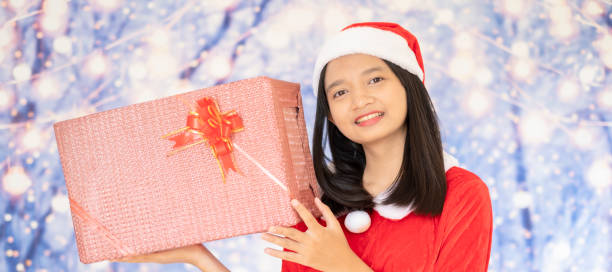 Happy Santa Claus girl on white background. Happy Santa Claus girl hold present box with snow background. late teens isolated on white one person cute stock pictures, royalty-free photos & images