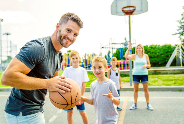 Happy basketball family portrait play this sport on summer season stock photo